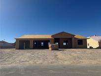 Unfinished house with two-car garage shows the framing under construction, with blue sky overhead at 6670 White Eagle Dr, Pahrump, NV 89061
