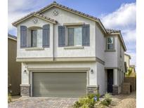 Charming two-story home with a well-maintained front yard and gray shutter details at 7061 Tilligerry St, North Las Vegas, NV 89084