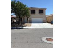 Inviting two-story home featuring a spacious driveway and a charming tree in the front yard at 7615 Paso Robles Ave, Las Vegas, NV 89113