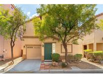 Charming two-story townhome featuring desert landscaping, an attached garage, and a welcoming green front door at 7923 Homer Ct, Las Vegas, NV 89139