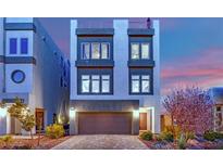Striking three-story home featuring clean lines, large windows, and a private rooftop deck, set against a colorful sunset sky at 8178 Eaton Hill St, Las Vegas, NV 89113