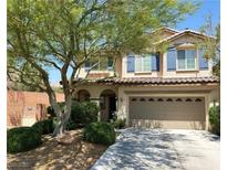 Charming two-story home featuring a well-maintained front yard and a spacious two-car garage at 8682 Gateway Glen Dr, Las Vegas, NV 89178