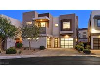Contemporary two-story home with modern design, stone accents, two-car garage, and desert landscaping at 881 Barrhead Ave, Henderson, NV 89012