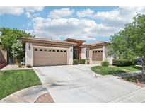 Charming single-story home with a well-manicured lawn and three-car garage, embodying suburban elegance at 10404 Stanberry Ave, Las Vegas, NV 89135