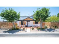 Charming single-story home with metal roof, white exterior, modern fence, and drought-tolerant landscaping at 108 Verdy Ln, Las Vegas, NV 89101