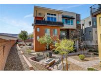 Contemporary three-story home with a fire pit, desert landscaping, and a spacious balcony at 10985 Limeslice Ave # 2, Las Vegas, NV 89135