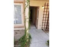 Welcoming front entrance with decorative trellis, climbing vines and covered porch at 1608 N Torrey Pines Dr # 103, Las Vegas, NV 89108
