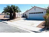 Charming single-story home with a well-maintained front yard, desert landscaping, and a two-car garage at 1860 Banaba Ln, Las Vegas, NV 89156