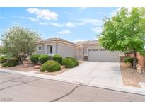 Charming single-story home featuring desert landscaping and a two-car garage at 2413 Mourning Warbler Ave, North Las Vegas, NV 89084