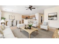 Inviting living room and kitchen with an open floor plan and natural light at 2538 Capella Star St, Henderson, NV 89044