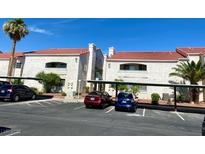 Condos with assigned covered parking featuring red tile roofs on a sunny day at 2725 S Nellis Blvd # 1158, Las Vegas, NV 89121