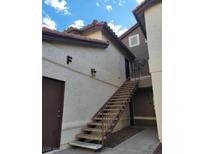 Exterior view of a two-story condo with an open stairwell and private entrance at 2995 E Sunset Rd # 237, Las Vegas, NV 89120