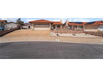 Charming single-story home with a two-car garage, desert landscaping, and a terracotta tile roof at 411 Monmouth Ct, Henderson, NV 89015