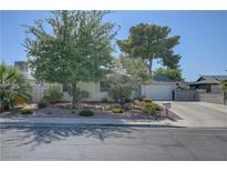 Charming single-story home with well-maintained landscaping and a driveway leading to the garage at 4445 Peterson Dr, Las Vegas, NV 89103