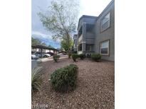 Apartment building exterior with well-maintained landscaping and covered parking at 555 E Silverado Ranch Blvd # 1123, Las Vegas, NV 89183