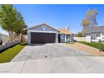 Charming single-story home with a well-manicured lawn and a paved driveway leading to a two-car garage at 6017 Montecito Way, Las Vegas, NV 89108
