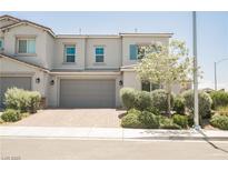Charming two-story townhome featuring a neutral color palette and manicured landscaping at 7002 Fossil Rim St, North Las Vegas, NV 89084