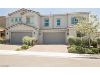Charming two-story townhome featuring a two-car garage and well-maintained front yard landscaping at 7002 Fossil Rim St, North Las Vegas, NV 89084
