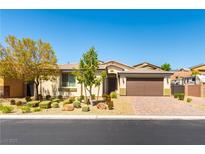 Charming single-story home with a two-car garage, complemented by a well-maintained front yard and desert landscaping at 7265 Southern Magnolia St, Las Vegas, NV 89149