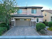 Charming two-story home featuring desert landscaping, brick driveway, and a spacious two-car garage at 7325 Perkins Hill St, Las Vegas, NV 89166