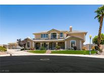 Charming two-story home featuring manicured lawn and mature palm trees at 7718 Willow Cove Cir, Las Vegas, NV 89129