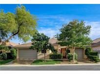 Charming single-story home with a well-manicured lawn and a two-car garage nestled in a lush landscape at 9921 Mirada Dr, Las Vegas, NV 89144