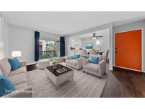 Cozy living room featuring modern furnishings and a bright, open floor plan with access to the balcony at 1405 Vegas Valley Dr # 98, Las Vegas, NV 89169