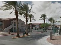 View of the community entrance with palm trees and well-maintained landscaping at 1505 Frank Aved St # 101, Las Vegas, NV 89110