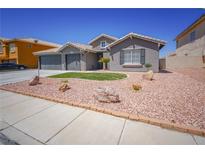 Charming single-story home featuring a well-manicured yard, neutral tones, and a two-car garage at 1519 Deerford Cir, Las Vegas, NV 89110