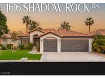 Charming single-story home featuring a tile roof, desert landscaping, and a spacious three-car garage at 1616 Shadow Rock Dr, Las Vegas, NV 89117