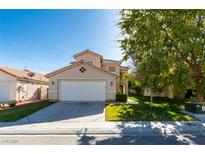 Charming two-story home featuring a well-manicured front yard and attached two-car garage at 1917 Badger Canyon Ave, North Las Vegas, NV 89031