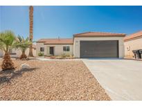 Charming single-story home with a well-maintained front yard and attached two car garage at 2719 Frangipani Ct, North Las Vegas, NV 89031
