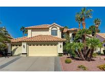 Charming home featuring a tile roof, desert landscaping, and an attached three car garage at 2917 Broken Willow Cir, Las Vegas, NV 89117