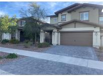 Two-story home with a neutral color palette, two-car garage, and desert landscaping at 330 Silva Pl, Henderson, NV 89011