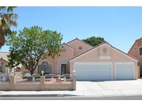 Charming single-story home boasts a well-manicured yard, two-car garage, and inviting curb appeal at 3519 W Red Coach Ave, North Las Vegas, NV 89031