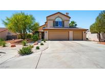 Inviting two-story home featuring a spacious three-car garage and mature desert landscaping in front yard at 419 Alonzo Ct, Las Vegas, NV 89123