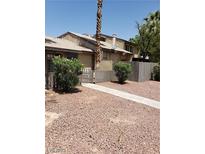 Inviting home with a neutral-toned exterior, a quaint, fenced yard, and easy to maintain landscaping at 4231 White Sands Ave, Las Vegas, NV 89121