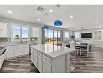 Bright kitchen with a large island, white cabinets, stainless steel appliances, and wood flooring at 424 Vigo Port St, Las Vegas, NV 89138