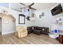 Comfortable living room with leather furniture, a ceiling fan, and modern decorations on the wall at 45 N Lamb Blvd, Las Vegas, NV 89110