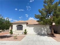 Charming single-story home featuring a tile roof, arched window, and a well-maintained two-car garage at 5376 S Conquistador St, Las Vegas, NV 89148