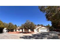 Charming single-story home with mature trees and a spacious driveway at 7255 W La Madre Way, Las Vegas, NV 89149