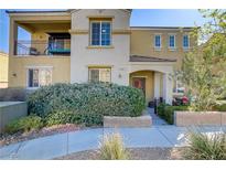 Inviting two-story home featuring a charming balcony and well-maintained landscaping at 7609 Trimming Ct, Las Vegas, NV 89149