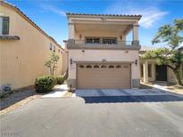 Two-story home featuring a balcony, a two-car garage, and desert landscaping in front at 7873 Running Doe Ct, Las Vegas, NV 89149