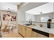 Bright kitchen featuring stone countertops, stainless steel appliances, a sleek black faucet, and modern light fixtures at 8000 Badura Ave # 1007, Las Vegas, NV 89113