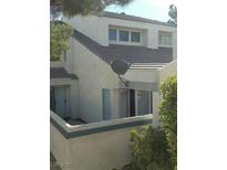 Two-story home featuring modern architecture and a private patio space perfect for relaxing outdoors at 8940 Antioch Way, Las Vegas, NV 89117