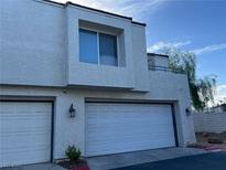 Inviting two-story home featuring a two-car garage and modern architectural details at 8940 Antioch Way, Las Vegas, NV 89117