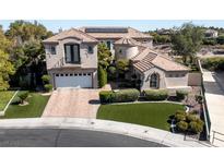Beautiful two-story home with a landscaped yard, brick driveway, and a two-car garage at 9301 Queen Charlotte Dr, Las Vegas, NV 89145