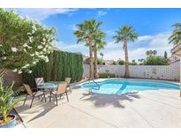 Beautiful backyard with a private pool, patio, and lush landscaping featuring palm trees, perfect for relaxing outdoors at , Henderson, NV 89074