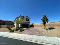Charming two-story home features a two-car garage, brick driveway, and low-maintenance landscaping at 10148 Cluny Ave, Las Vegas, NV 89178