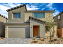 Charming two-story home with desert landscaping, a two-car garage and an inviting orange front door at 10198 Eden Mountain St, Las Vegas, NV 89141